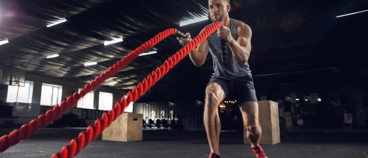 young-healthy-man-athlete-doing-exercise-with-ropes-gym-single-male-model-practicing-hard-training-his-upper-body-concept-healthy-lifestyle-sport-fitness-bodybuilding-wellbeing